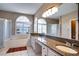Bathroom boasts a granite vanity and large mirror at 12922 Prestwick Dr, Riverview, FL 33579