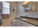 Bathroom with granite countertop, single sink vanity, and mirrored medicine cabinet at 12922 Prestwick Dr, Riverview, FL 33579