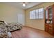 Bedroom with twin bed, wood flooring, and built-in wooden cabinet at 12922 Prestwick Dr, Riverview, FL 33579