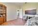 Bedroom with twin bed, wood flooring, and a view of the kitchen at 12922 Prestwick Dr, Riverview, FL 33579