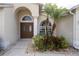 Front entrance with double doors and lush landscaping at 12922 Prestwick Dr, Riverview, FL 33579