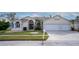 Beautiful two-story home with a three-car garage and manicured lawn at 12922 Prestwick Dr, Riverview, FL 33579