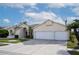 Front view of a house with a three-car garage at 12922 Prestwick Dr, Riverview, FL 33579