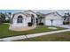 Two-story house with a two-car garage and landscaped yard at 12922 Prestwick Dr, Riverview, FL 33579