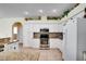 Modern kitchen with white cabinets, granite countertops, and stainless steel appliances at 12922 Prestwick Dr, Riverview, FL 33579