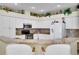 L-shaped kitchen with granite island and breakfast bar at 12922 Prestwick Dr, Riverview, FL 33579