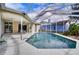 Large refreshing blue swimming pool with a screened patio enclosure at 12922 Prestwick Dr, Riverview, FL 33579