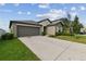 House exterior with a two-car garage and driveway at 13541 Wild Ginger St, Riverview, FL 33579