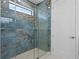 Spa-like bathroom with a frameless glass shower and blue tile at 13750 Park Blvd # 1, Seminole, FL 33776