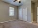 Bedroom with neutral walls, carpet flooring, window with blinds, and double sliding door closet at 13913 Sage Thrasher Ln, Riverview, FL 33579