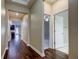 Bright hallway with dark hardwood floors, leading to bedrooms and a bathroom at 13913 Sage Thrasher Ln, Riverview, FL 33579