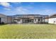 Spacious backyard featuring a screened pool and patio at 15314 Valencia Del Sol St, Wimauma, FL 33598