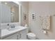 Small bathroom with white vanity and toilet at 15314 Valencia Del Sol St, Wimauma, FL 33598