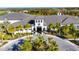 This is a beautiful clubhouse with manicured landscaping and palm trees surrounding the building at 15314 Valencia Del Sol St, Wimauma, FL 33598