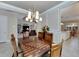 Formal dining room with wood table and chairs, offering views into the living area at 15314 Valencia Del Sol St, Wimauma, FL 33598