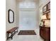 Bright entryway with double doors and a bench at 15314 Valencia Del Sol St, Wimauma, FL 33598