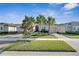 Two-story house with a two-car garage and palm trees at 15314 Valencia Del Sol St, Wimauma, FL 33598