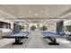 Game room with two pool tables and comfortable seating at 15314 Valencia Del Sol St, Wimauma, FL 33598