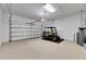 Garage with golf cart and storage space at 15314 Valencia Del Sol St, Wimauma, FL 33598