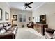Comfortable Gathering room featuring leather sofas, a large TV, and a ceiling fan at 15314 Valencia Del Sol St, Wimauma, FL 33598