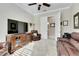 Relaxing Gathering room with leather furniture, a large TV, and plenty of natural light at 15314 Valencia Del Sol St, Wimauma, FL 33598