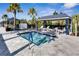 Inviting hot tub with nearby lounge chairs shaded by cabanas, perfect for relaxation at 15314 Valencia Del Sol St, Wimauma, FL 33598