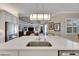 Spacious kitchen with island, stainless steel appliances, and white cabinetry at 15314 Valencia Del Sol St, Wimauma, FL 33598