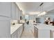 Bright kitchen with white cabinets, stainless steel appliances, and an island at 15314 Valencia Del Sol St, Wimauma, FL 33598