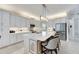 Modern kitchen features white cabinets, a large island, and stainless steel appliances at 15314 Valencia Del Sol St, Wimauma, FL 33598