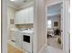 Laundry room with washer, dryer, and cabinets at 15314 Valencia Del Sol St, Wimauma, FL 33598