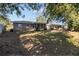 Spacious backyard with mature trees and screened patio at 2085 Georgianna St, Largo, FL 33774