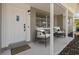 Covered porch with stylish seating and a modern door at 2085 Georgianna St, Largo, FL 33774
