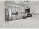 Modern kitchen featuring white cabinets, quartz countertops, and stainless steel appliances at 2085 Georgianna St, Largo, FL 33774