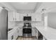 White kitchen with quartz countertops and stainless steel appliances at 2085 Georgianna St, Largo, FL 33774