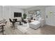 Open living room with L-shaped sofa and wood-look floors at 2085 Georgianna St, Largo, FL 33774