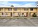 Yellow two-story townhouses with white picket fences and parking in front at 22706 Gage Loop # 34, Land O Lakes, FL 34639