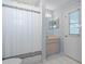 Clean bathroom with shower, sink, and exterior access at 22921 Sterling Manor Loop, Lutz, FL 33549