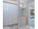 Bathroom with shower, sink, and pool access at 22921 Sterling Manor Loop, Lutz, FL 33549