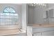 Bathroom with a large vanity and a soaking tub at 22921 Sterling Manor Loop, Lutz, FL 33549