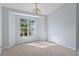 Formal dining room with large window and chandelier at 22921 Sterling Manor Loop, Lutz, FL 33549