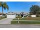 Single-story home with attached garage and landscaped yard at 22921 Sterling Manor Loop, Lutz, FL 33549