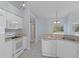 Galley kitchen with white cabinets and modern appliances at 22921 Sterling Manor Loop, Lutz, FL 33549