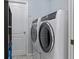 Laundry room with washer, dryer, and shelving at 22921 Sterling Manor Loop, Lutz, FL 33549