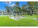 Outdoor picnic area with grills and tables under umbrellas at 2400 Winding Creek Blvd # 24-203, Clearwater, FL 33761
