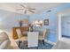 Dining area with glass table and four chairs, open to kitchen at 2400 Winding Creek Blvd # 24-203, Clearwater, FL 33761