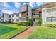 Condo building exterior with walkway and landscaping in daytime at 2400 Winding Creek Blvd # 24-203, Clearwater, FL 33761
