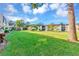 A landscaped lawn between residential buildings on a bright sunny day beneath a blue, cloudy sky at 2400 Winding Creek Blvd # 24-203, Clearwater, FL 33761