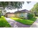 Well-maintained building exterior with lush landscaping at 2400 Winding Creek Blvd # 24-203, Clearwater, FL 33761