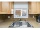Double stainless steel sink in condo kitchen with light wood cabinets at 2400 Winding Creek Blvd # 24-203, Clearwater, FL 33761