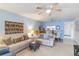 Living room with light beige couch and view to dining area and kitchen at 2400 Winding Creek Blvd # 24-203, Clearwater, FL 33761